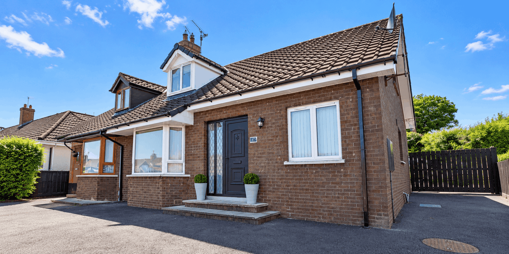 Completed home improvement project with new windows, door and roofline