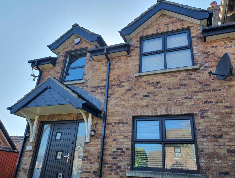 Anthracite grey uPVC windows on a red brick home