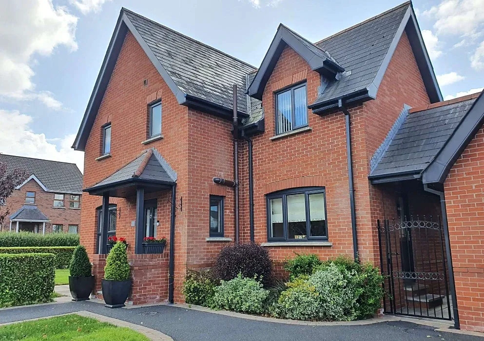 Red brick home in Belfast with grey uPVC fascia boards and guttering