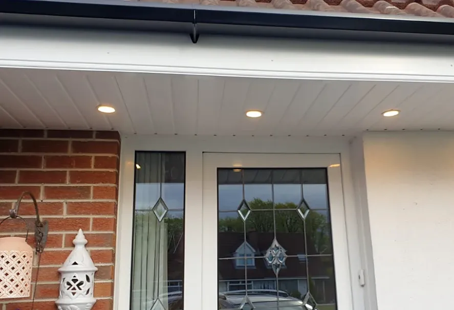 White uPVC soffit board with downlights above a front door